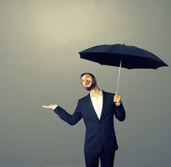 smiley businessman with umbrella