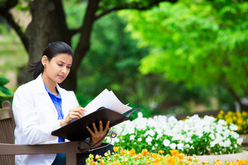 Doctor analyzing data outside