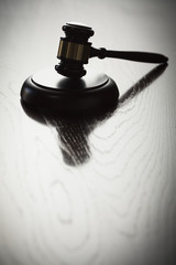Dramatic Gavel Silhouette on Reflective Wood