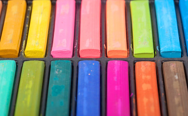 Detail of different colored chalk painting on white background