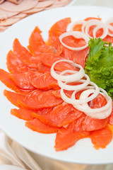 Salmon Sliced with onion on white plate