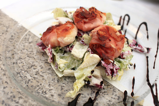 Fried Goat Cheese In Bacon On Glass Plate