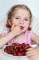 cute little girl eating cherries