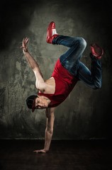 Man dancer showing break-dancing moves