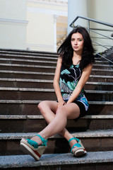 beautiful young girl sitting on stairs