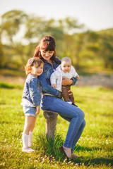 Fototapeta premium Happy family outdoors on the grass in the Park