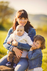 Happy family outdoors on the grass in the Park