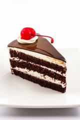 Chocolate cake slice with red cherry fruit.