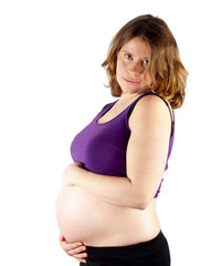 Pregnant young woman holding her naked belly