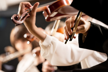 Violinists performing, hands close-up