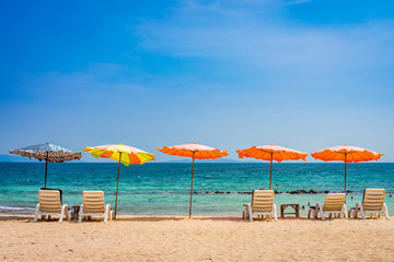 Beach umbrella and sunbath seats and side table