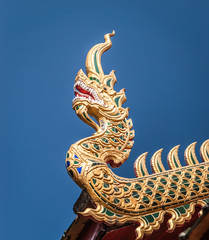 Fototapeta na wymiar Thailands golden dragon head by old temple.