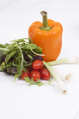 Salad, tomatoes, spring onions and orange pepper isolated on whi