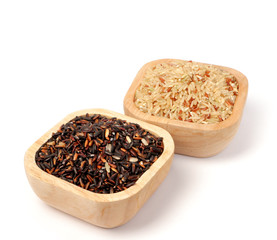 Uncooked thai black  rice in a wooden bowls
