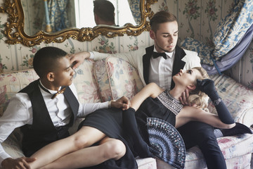 Two gentlemen, one lady in luxury apartment