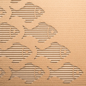 Fishes cut out on a corrugated cardboard