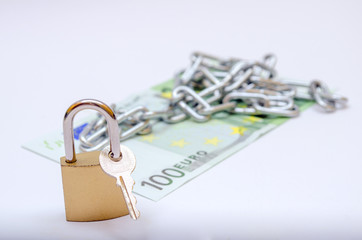 euro bill with padlock and chain