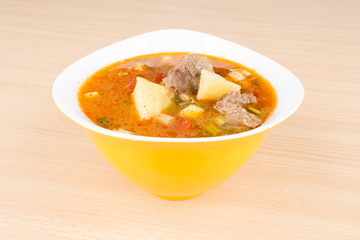 Goulash soup in a yellow bowl