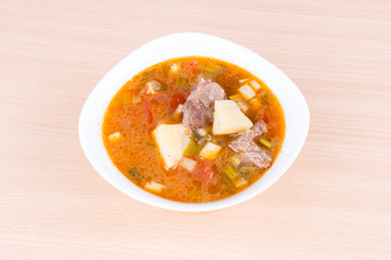 Goulash soup in a yellow bowl