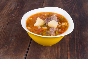 Goulash soup in a yellow bowl