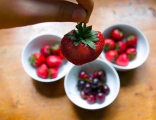 Bowls of cherries and strawberries