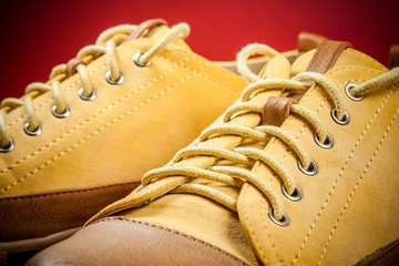 yellow sneakers on red background - 65877557