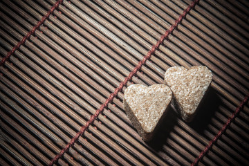 two sugar hearts on wooden texture - 65877745