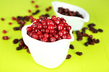 Fresh and dry cranberry in pitchers and bowl