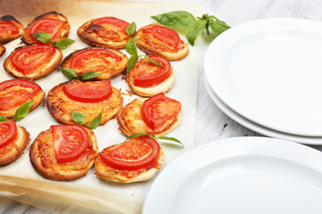 Small pizzas on baking paper close up