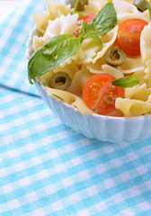 Delicious pasta with tomatoes on plate on table close-up