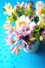 Fototapeta na wymiar Bouquet of freesias in pail on table close-up