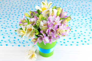 Bouquet of freesias in pail on table close-up