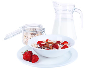Healthy cereal in bowl with milk and strawberries isolated