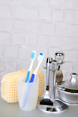 Male luxury shaving kit on shelf in bathroom