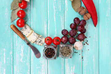 Different types of cheese with vegetables and spices