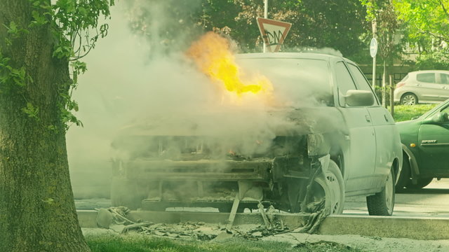 Car engulfed in flames with lot of smoke