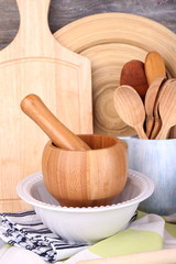 Composition of wooden cutlery, pan, bowl and cutting board
