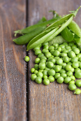 Fresh green peas on wooden background