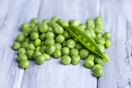 Fresh green peas on wooden background
