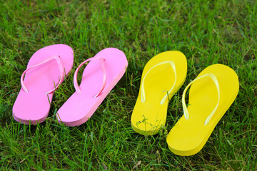 Bright flip-flops on green grass