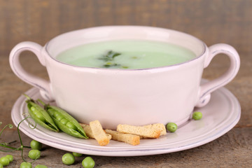 Tasty peas soup on wooden table