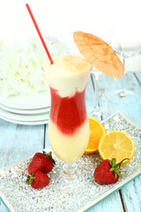 Delicious fruit smoothie on wooden table, close up