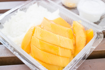 Close up dessert box of sweet mango and sticky rice