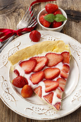 Piece of strawberry tart on rustic wooden table
