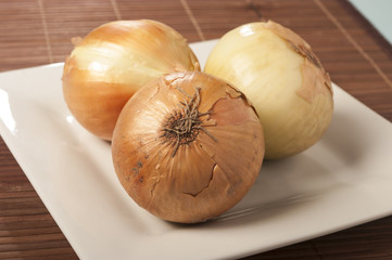 Onion on wooden background close up