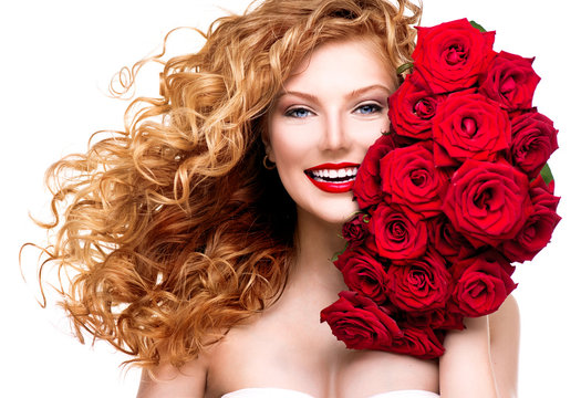 Beauty woman with long permed red hair and beautiful red roses