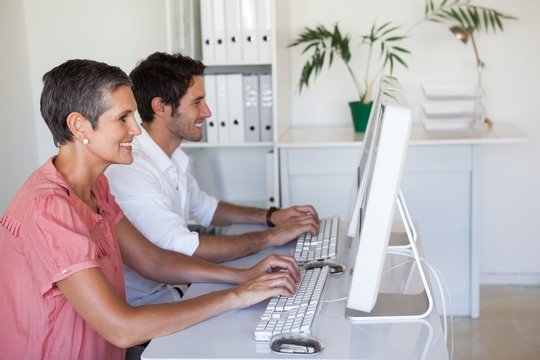 Casual business team working at desk using computers