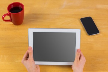 Businesswoman using tablet at desk