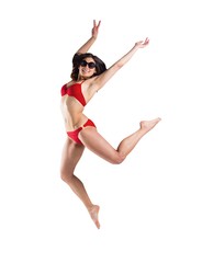 Fototapeta premium Fit girl in red bikini smiling and leaping