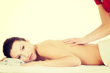 Fototapeta na wymiar Preaty woman relaxing beeing massaged in spa